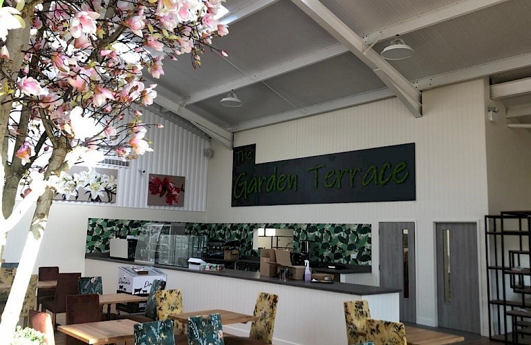 Bespoke moss signage and artificial magnolia trees - Garden Centre restaurant refurb project